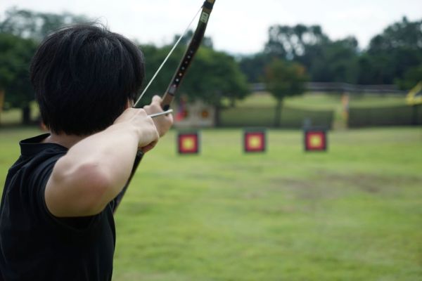Person aiming a bow and arrow