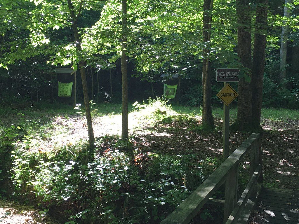 A wooded archery range trail with a range sign