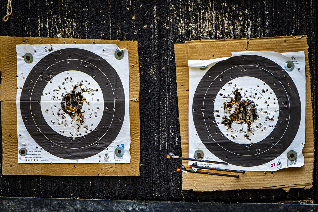 Two paper target faces showing tight arrow groups